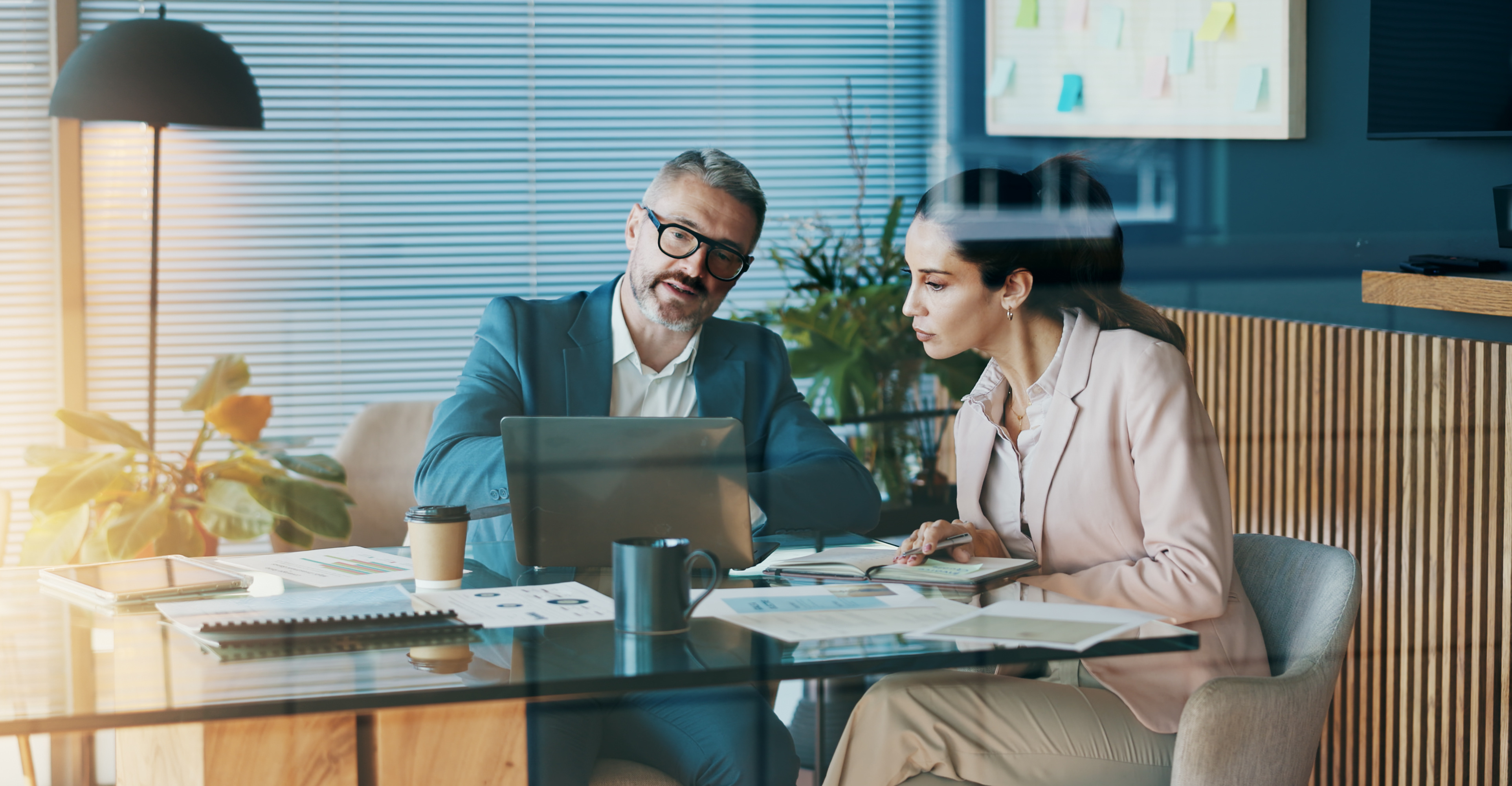 Stock photo of marketers sitting at a desk working on a campaign
