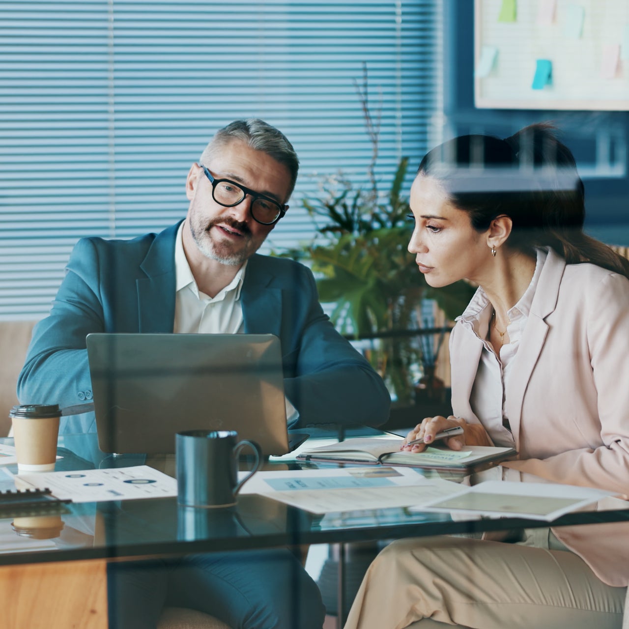 Stock photo of marketers sitting at a desk working on a campaign