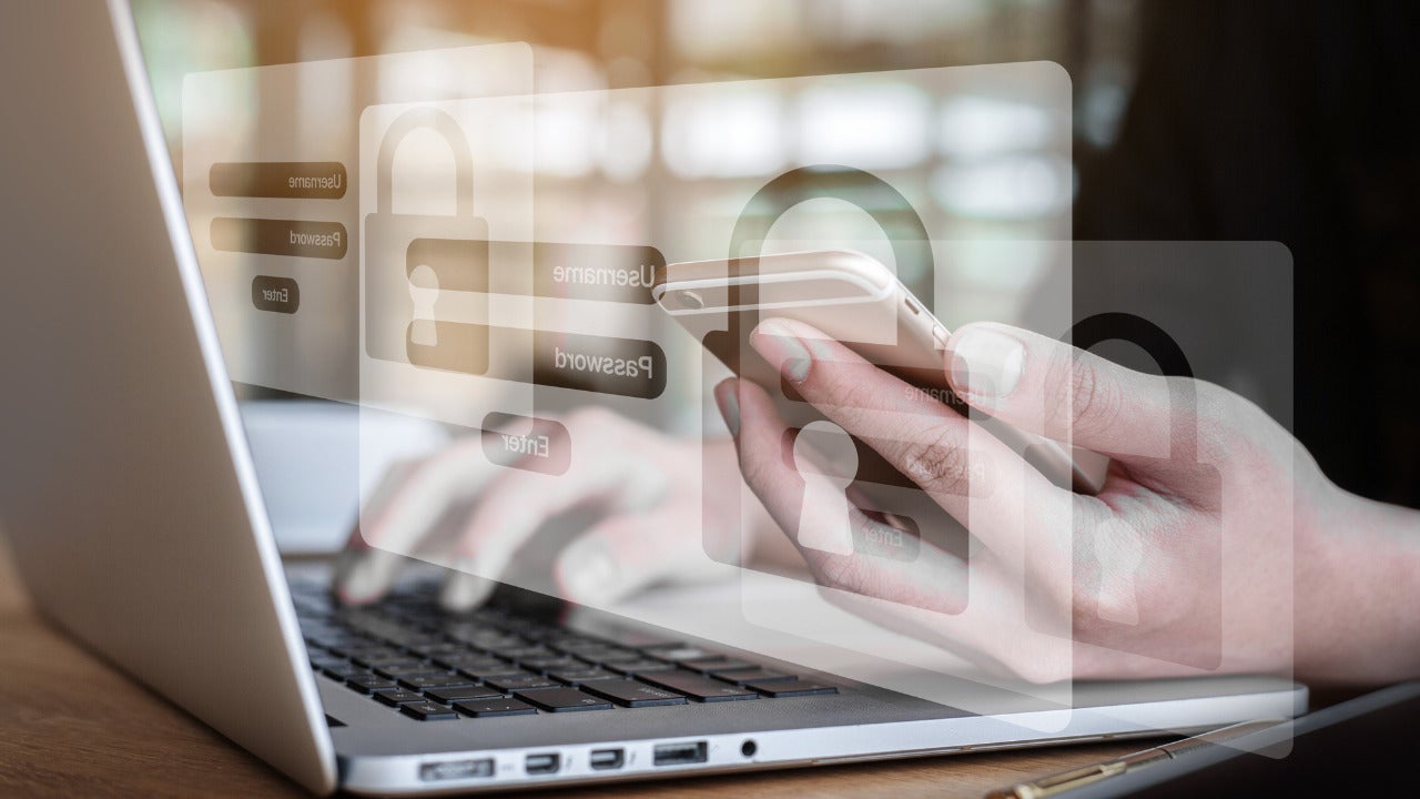 Someone using a computer and getting a multi factor authentication code for security