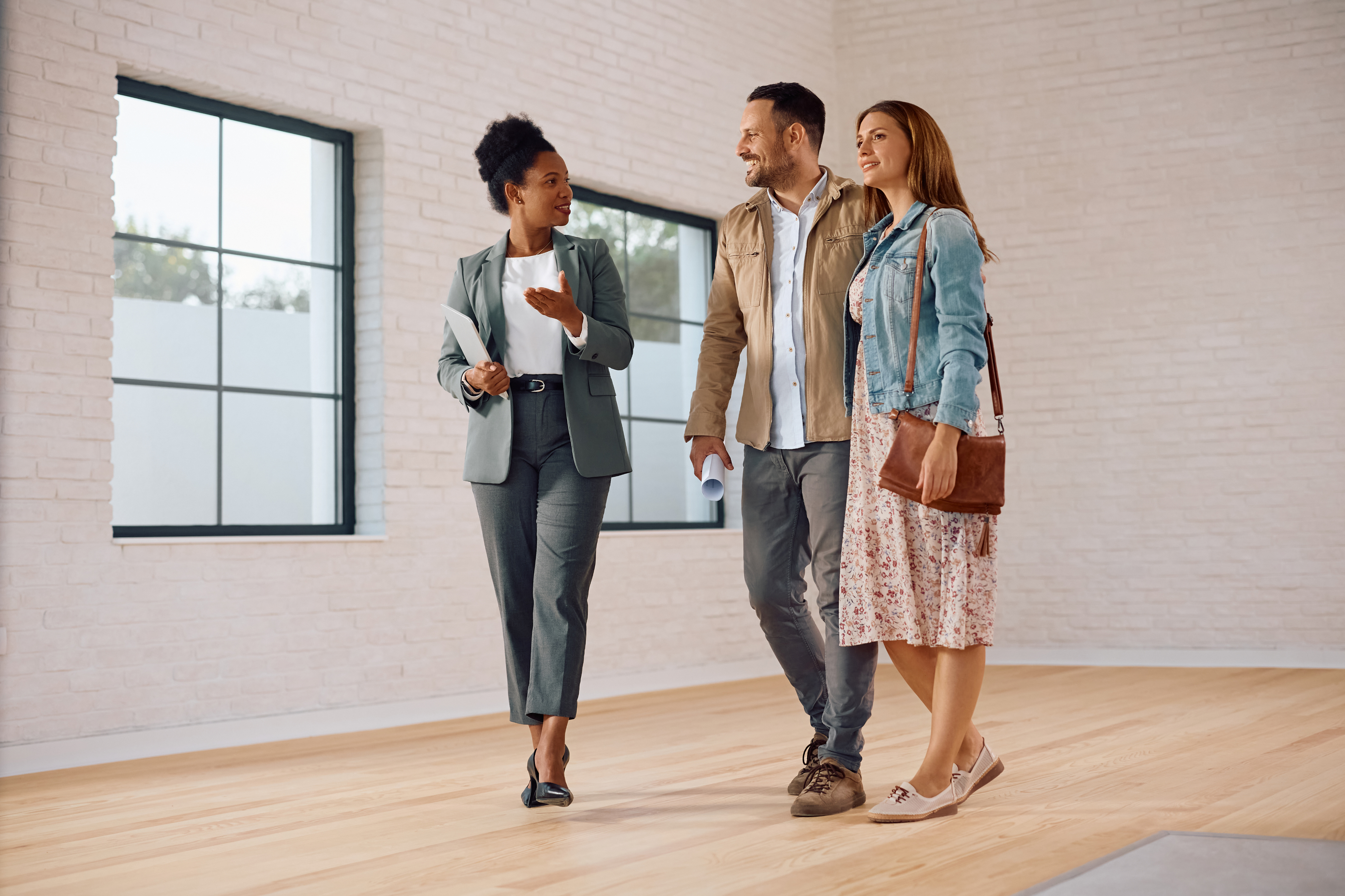 A couple seen playing with golden retriever dog.