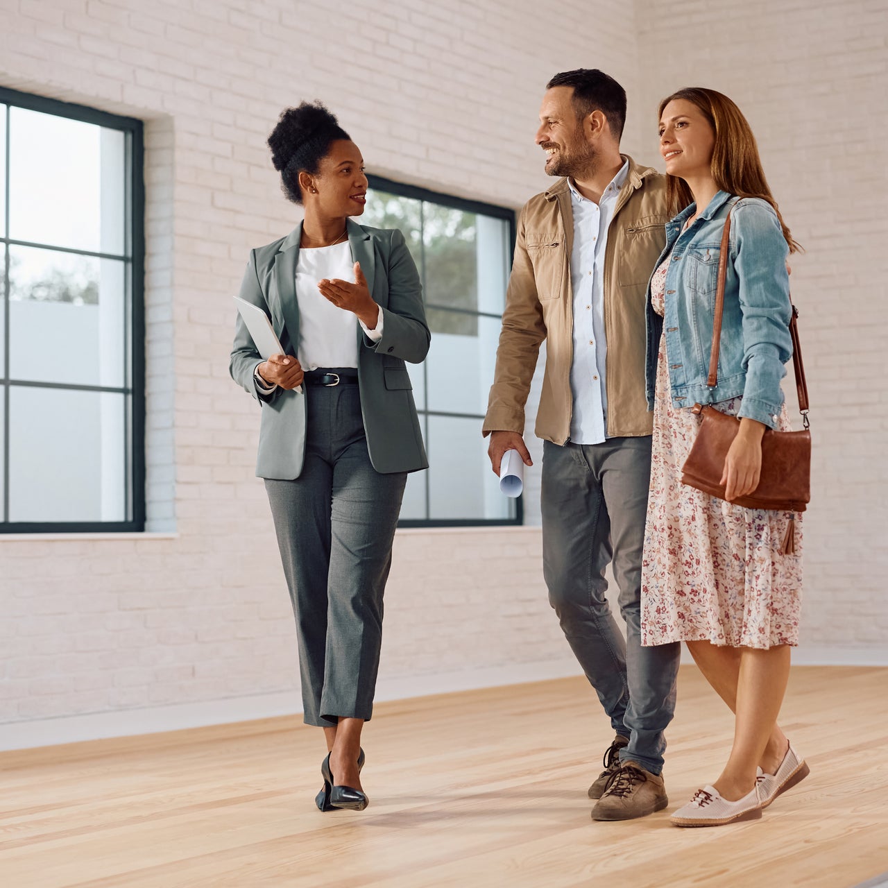 A couple seen playing with golden retriever dog.