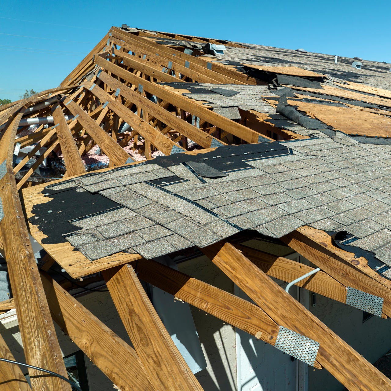 A view of a damaged roof, likely due to strong winds or a storm.
