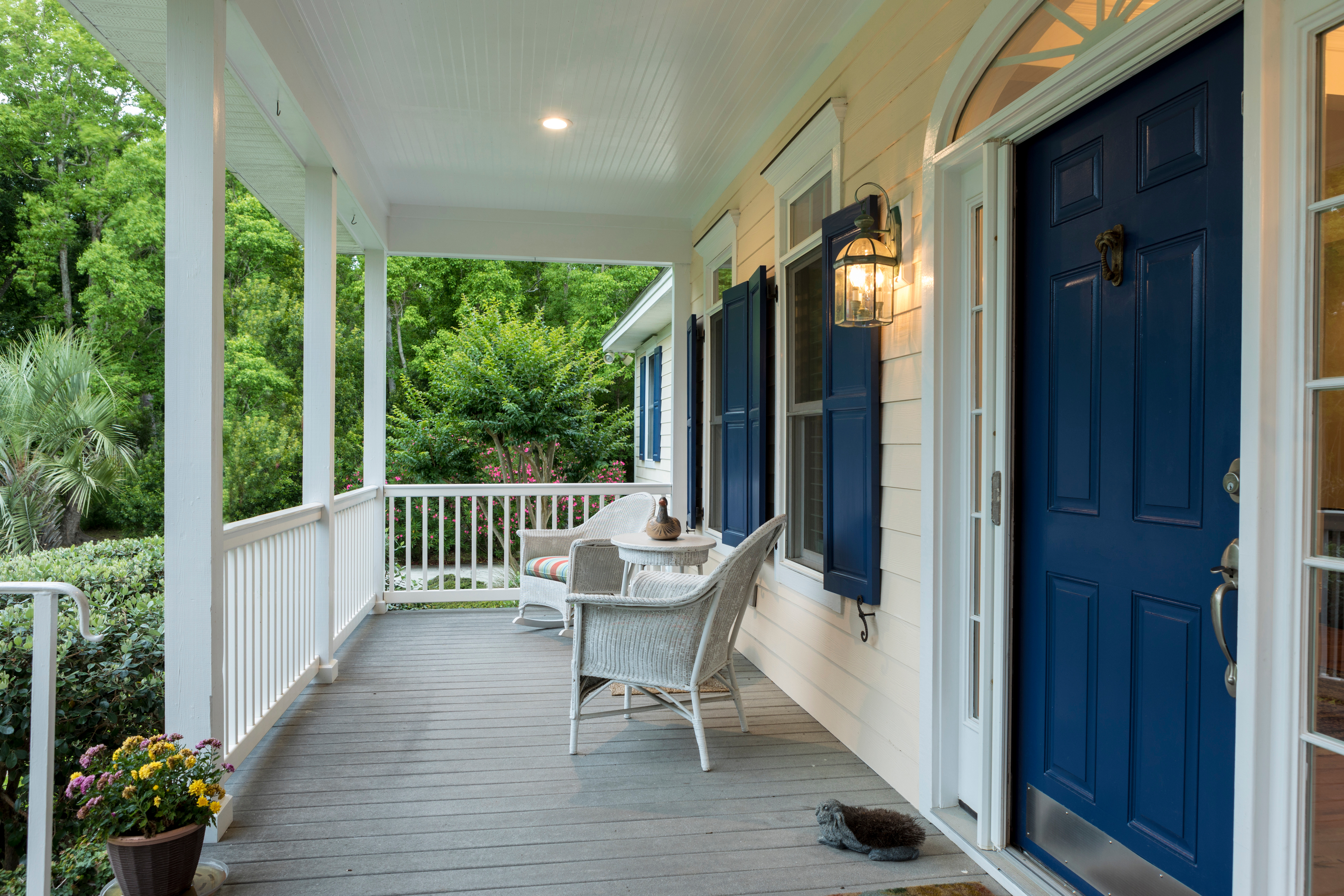 A middle class house porch with greenery.