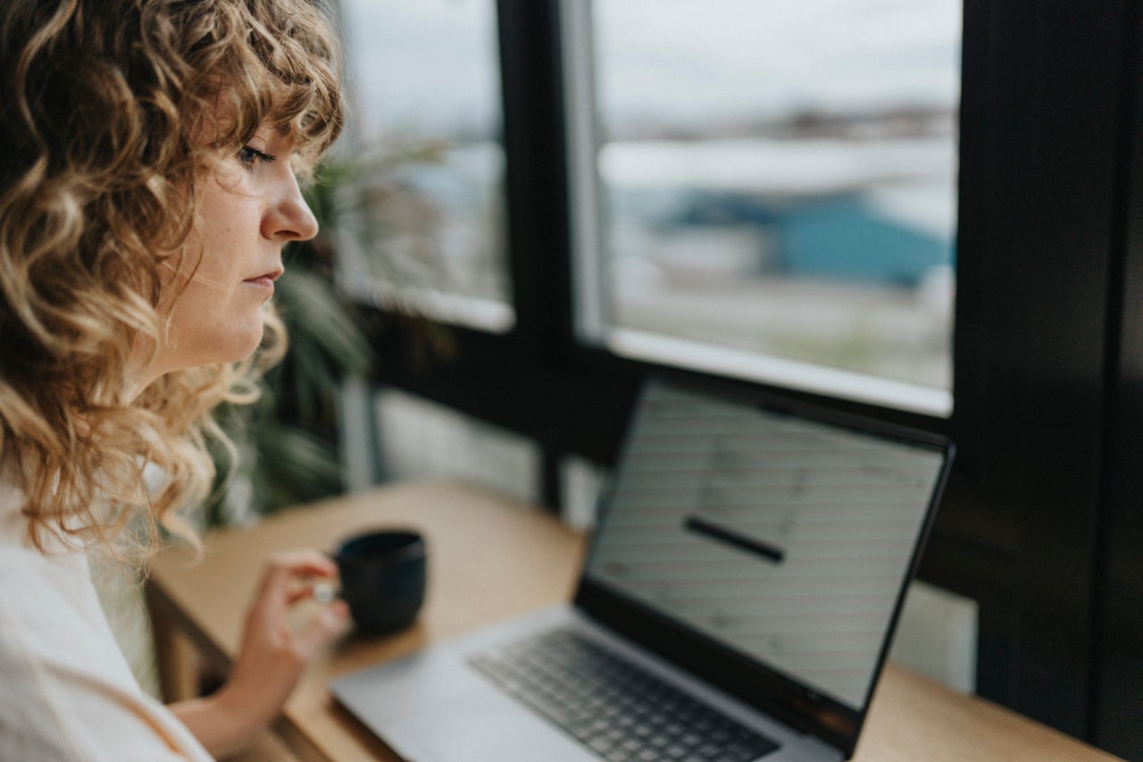 Woman sitting at a desk looking at a computer