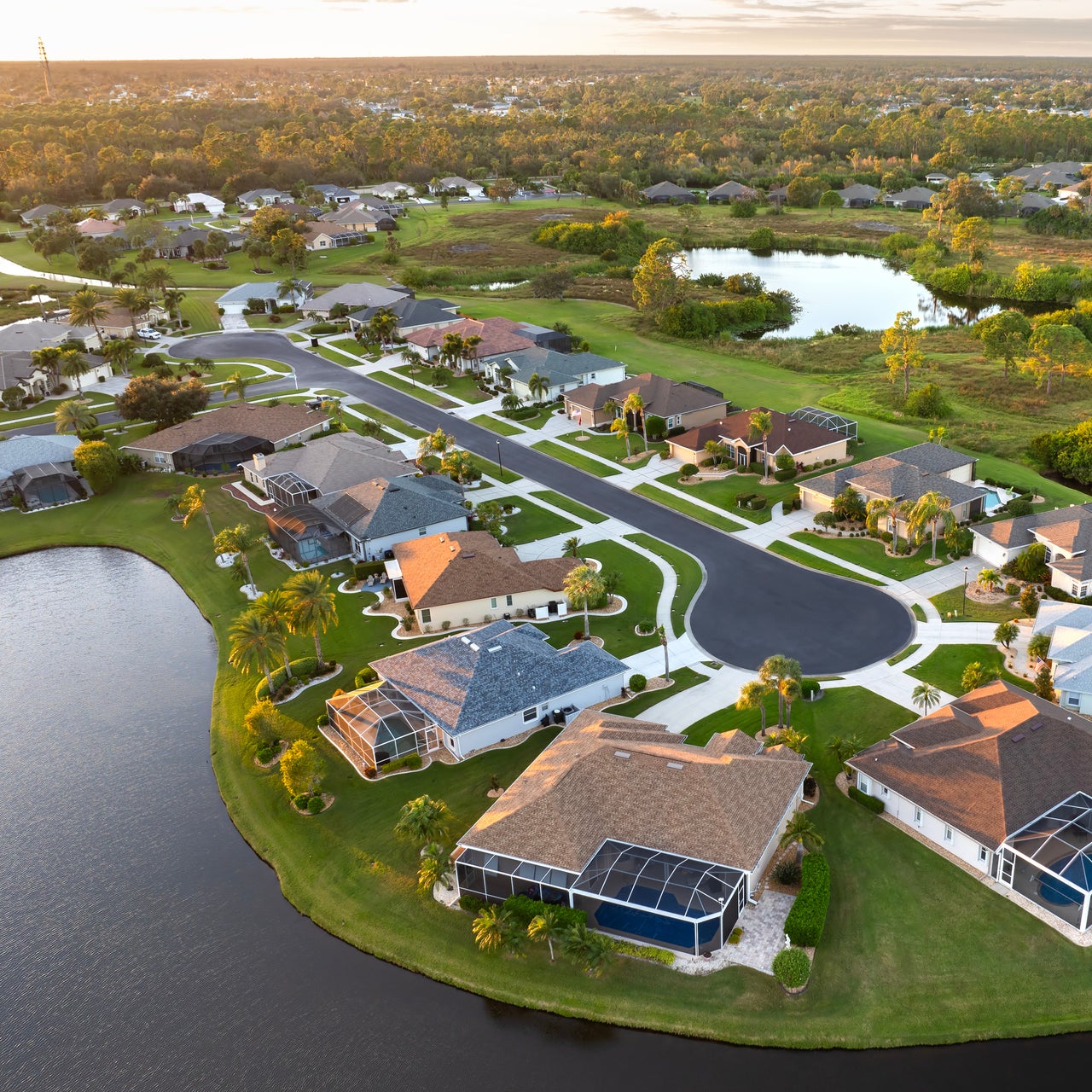 An aerial view of a suburban neighborhood with streams of water.