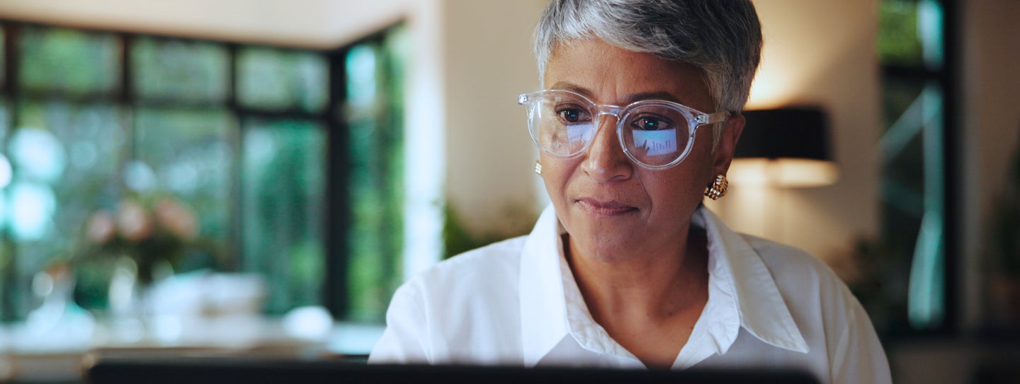 A woman peering into her computer