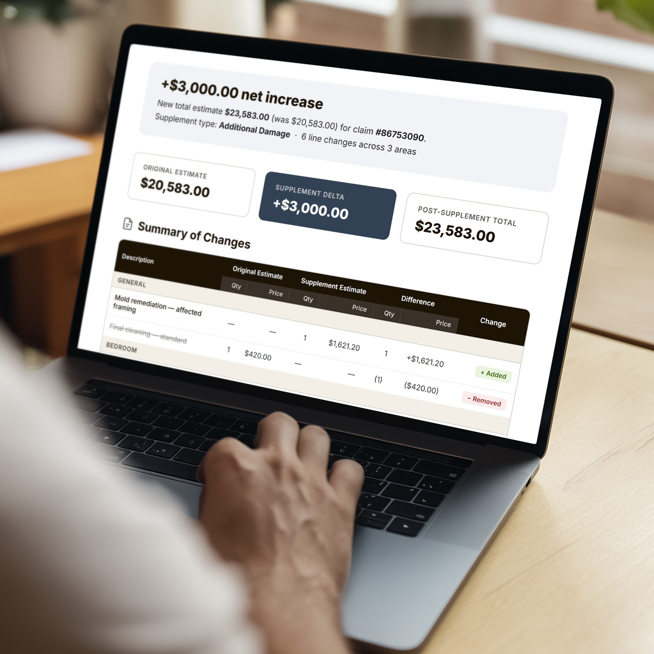 An adjuster reviews a side-by-side report on a laptop that automatically highlights added and removed line items.