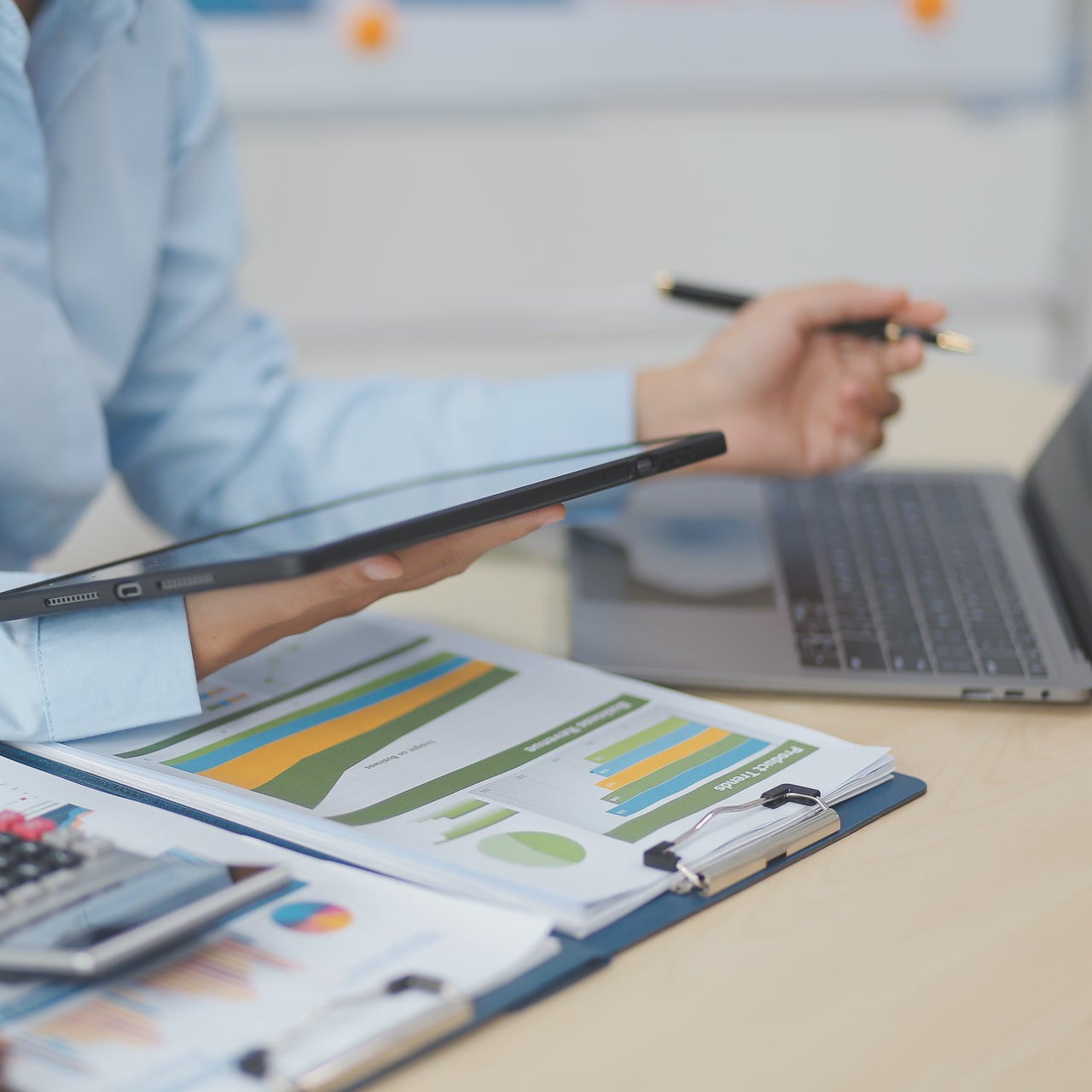 Auditor searching through legal documents and preparing paperwork or report for analysis during tax time