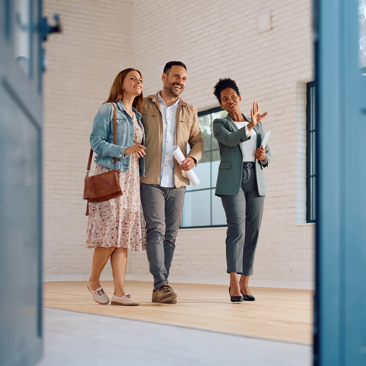 A real estate agent showing a house to a couple.