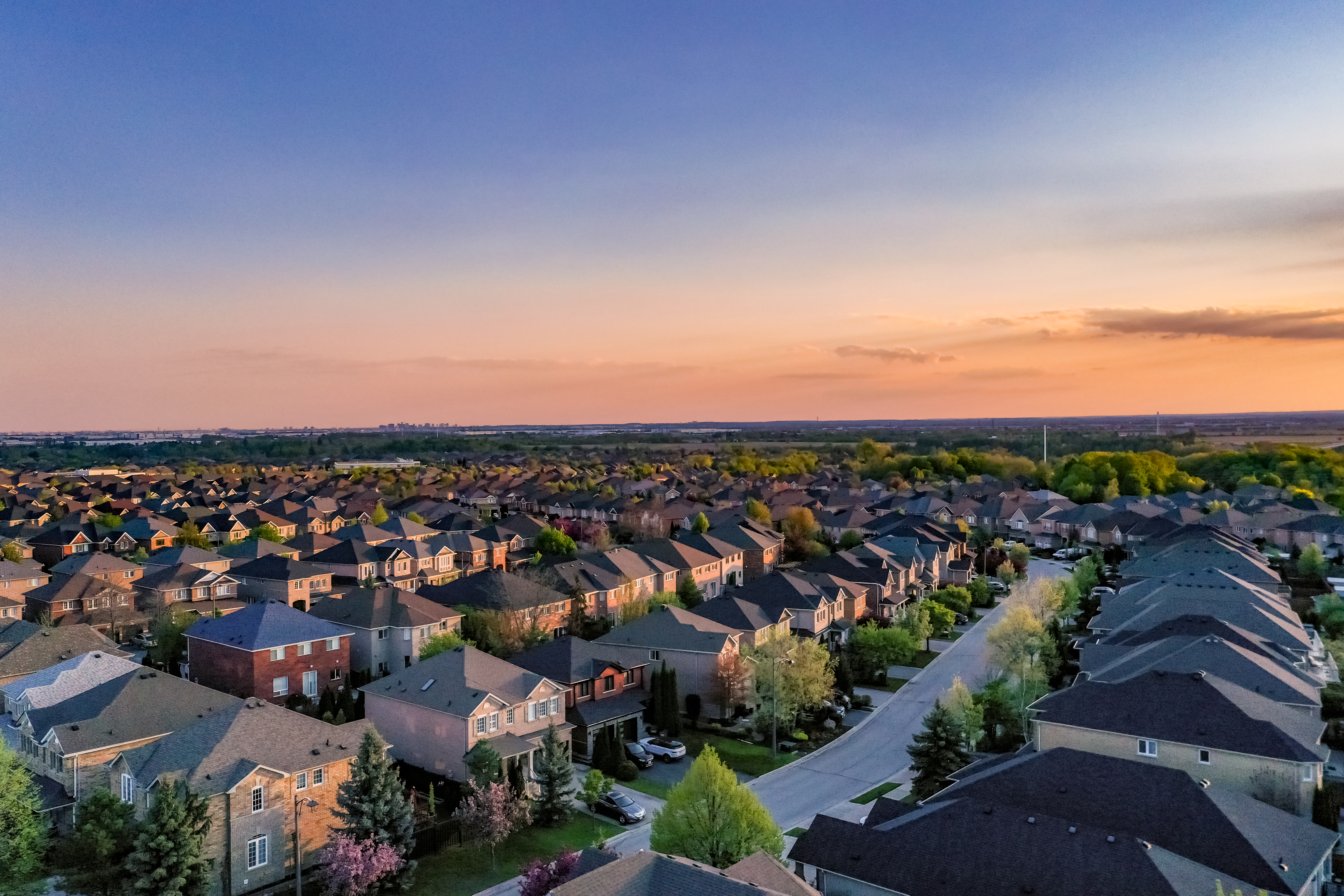 An aerial view of a residential area, likely taken during the evening. 