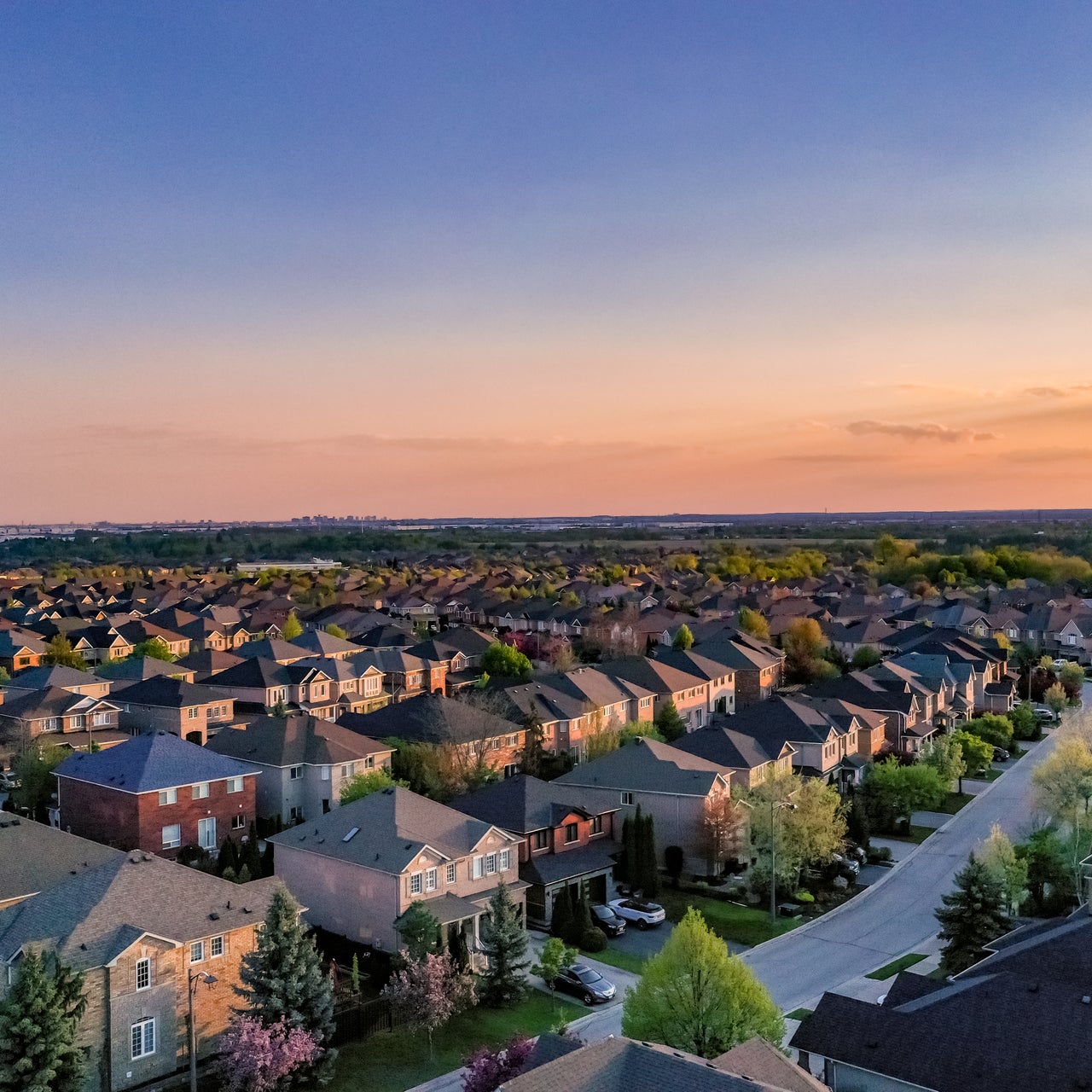 An aerial view of a residential area, likely taken during the evening.