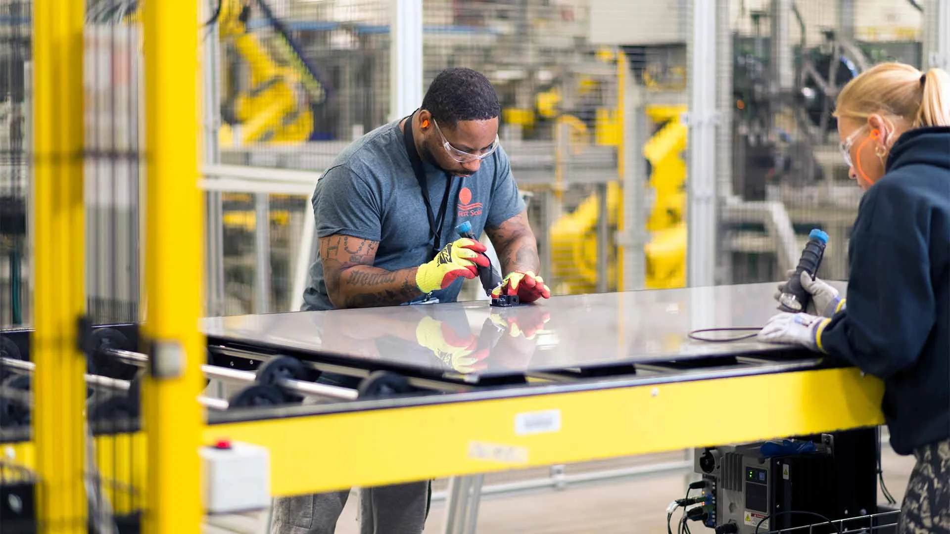 Two people working in an advanced manufacturing facility