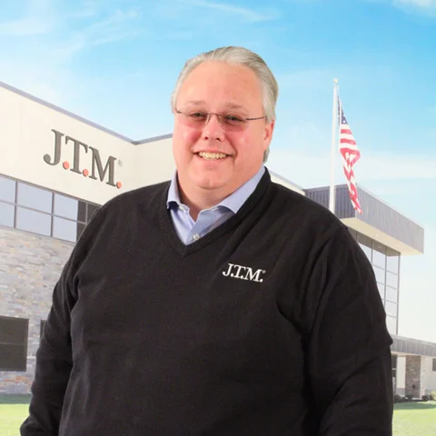 Brian Hofmeier headshot with JTM building in background