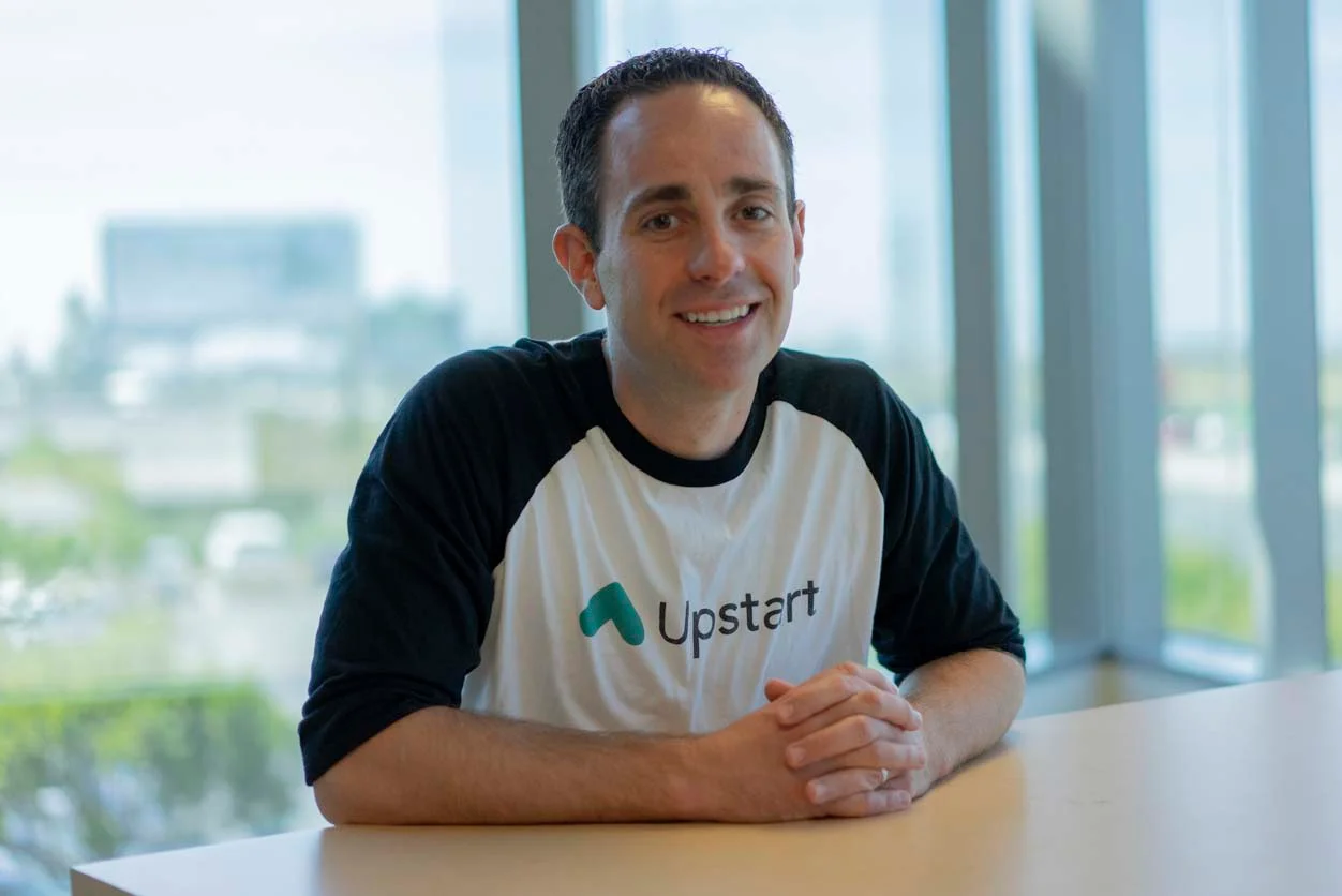 Corporate Governance - A smiling man wearing an Upstart shirt