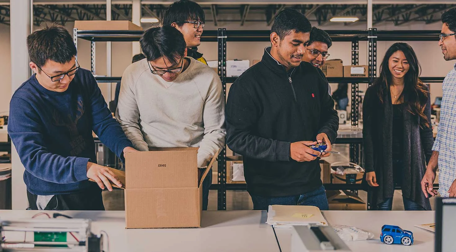 Talent workers in a warehouse testing electronics