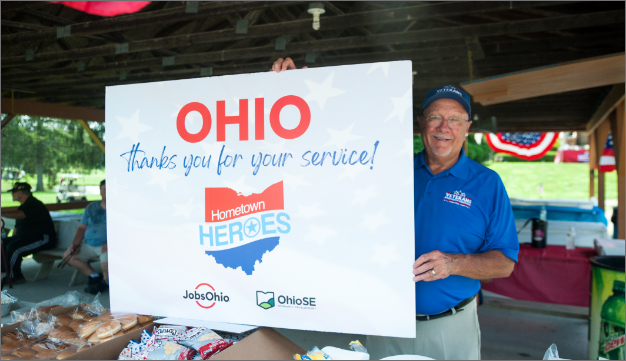 A man holding a sign that says OHIO thanks you for your service!