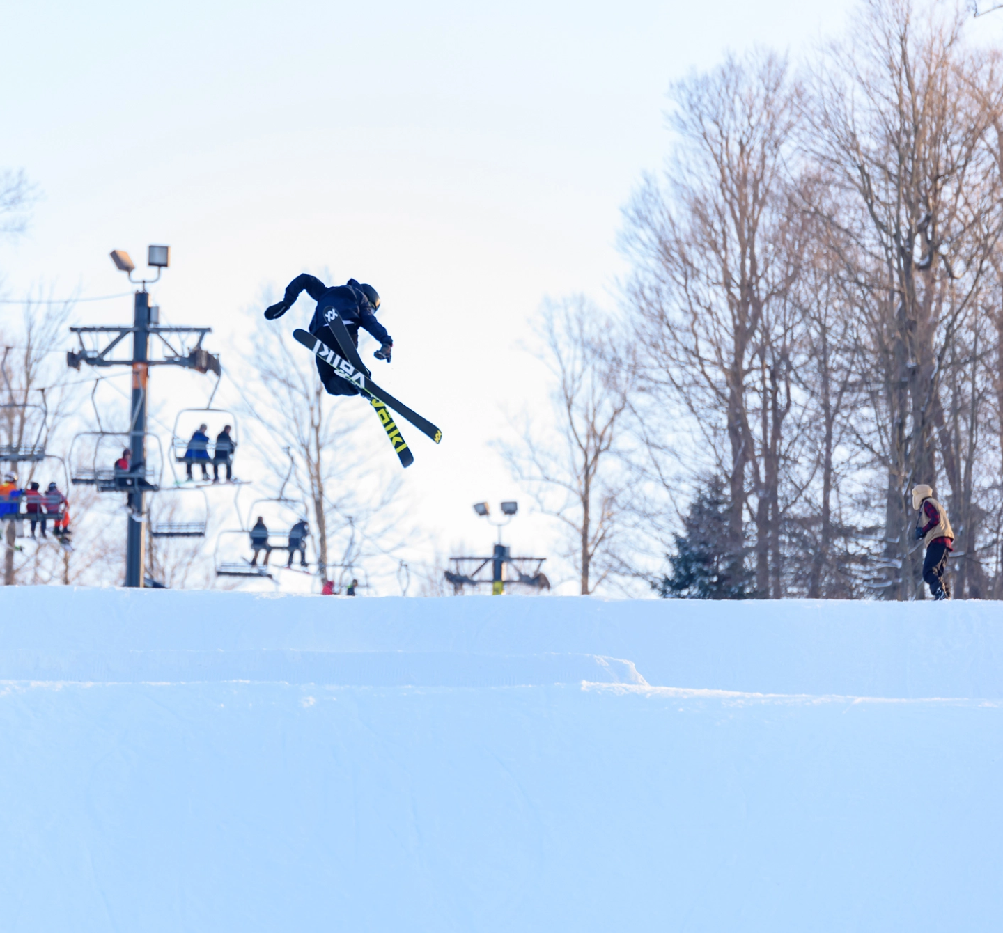 An expert skier getting air off a jump