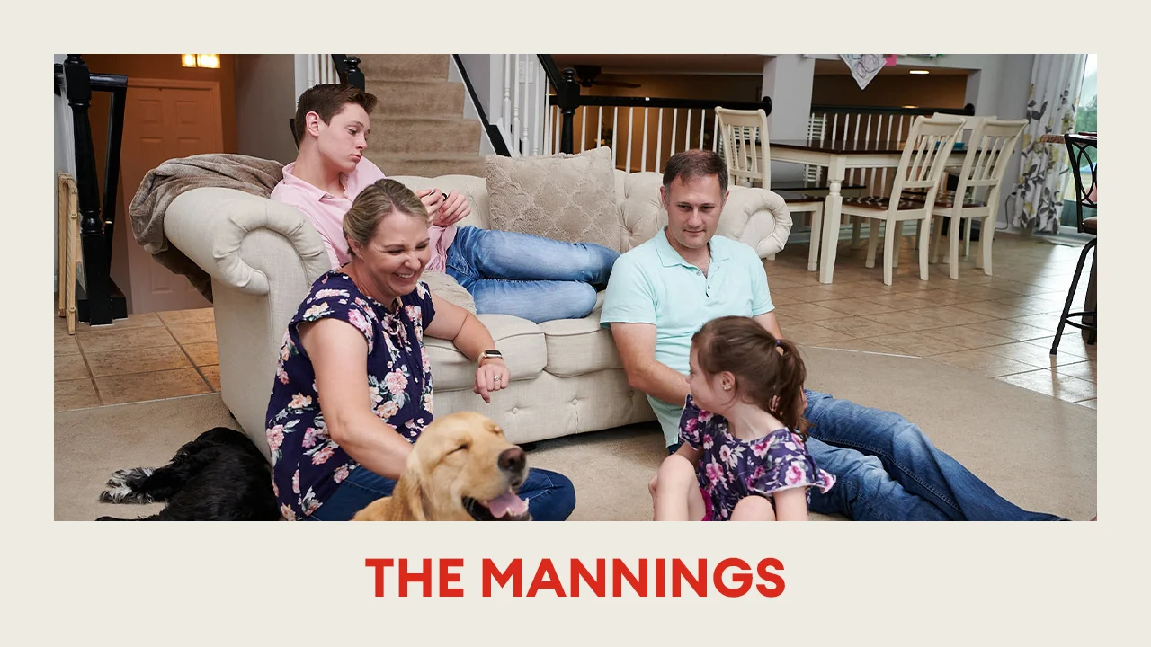 The Mannings family sitting together with their dogs