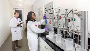 Two Halliburton lab employees in lab coats.