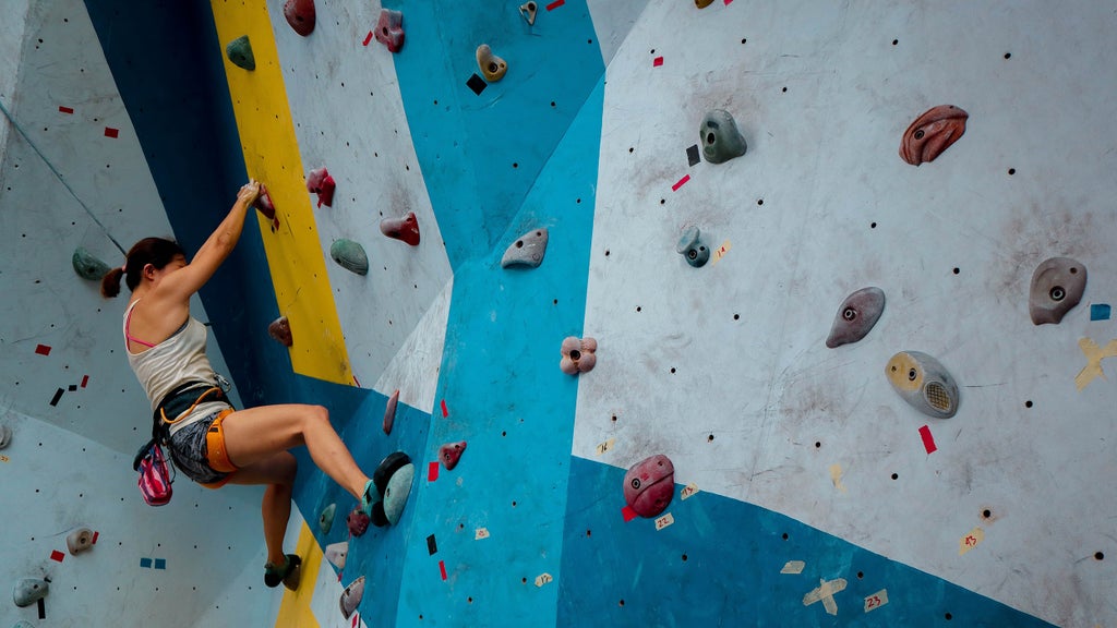woman rock climbing indoors