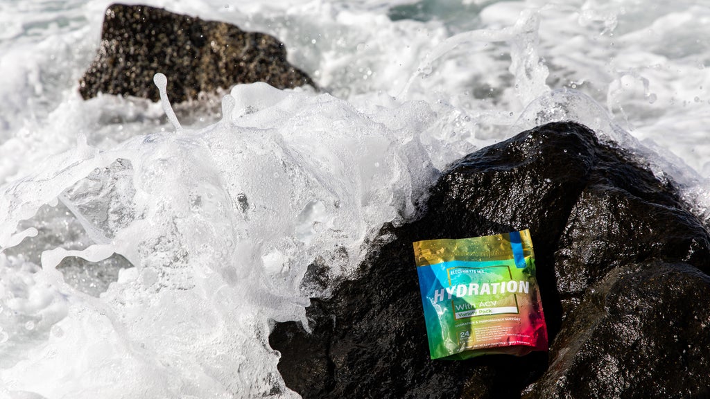 Essential elements Hydration Variety 24-Pack on a rock in the ocean