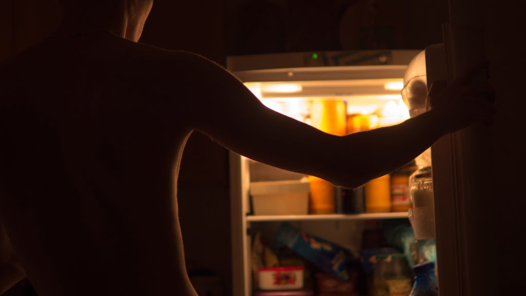 man in front of the fridge for a late night snack