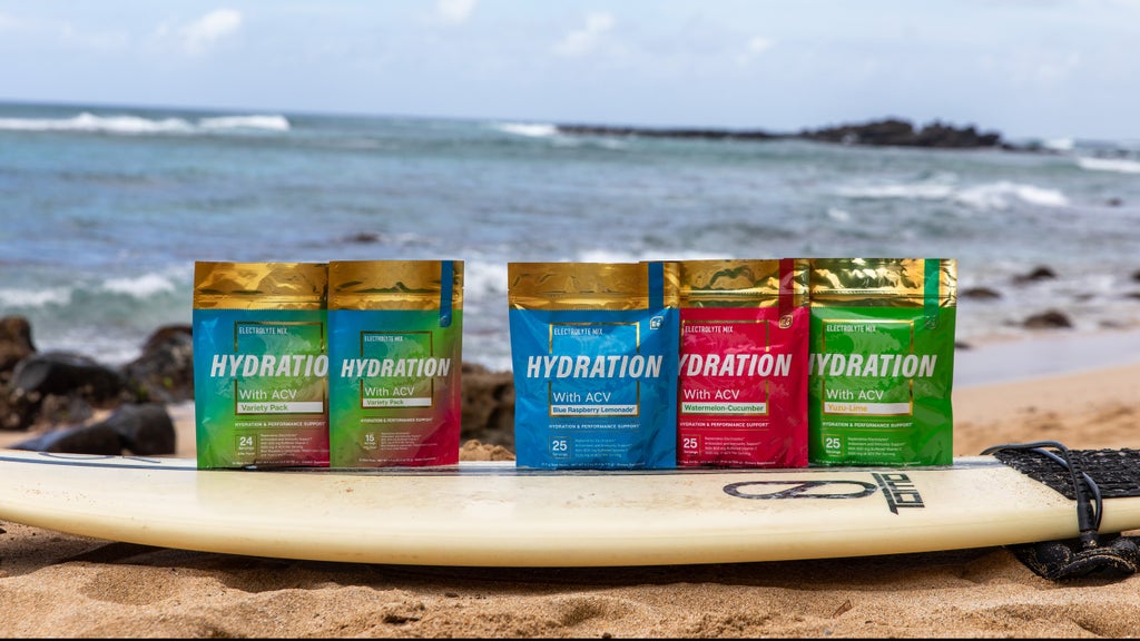 Essential elements Hydration product packages on a surf board at the beach