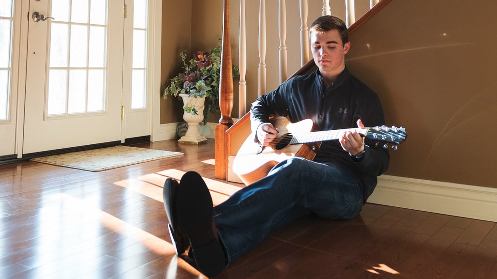 young man playing guitar and relaxing