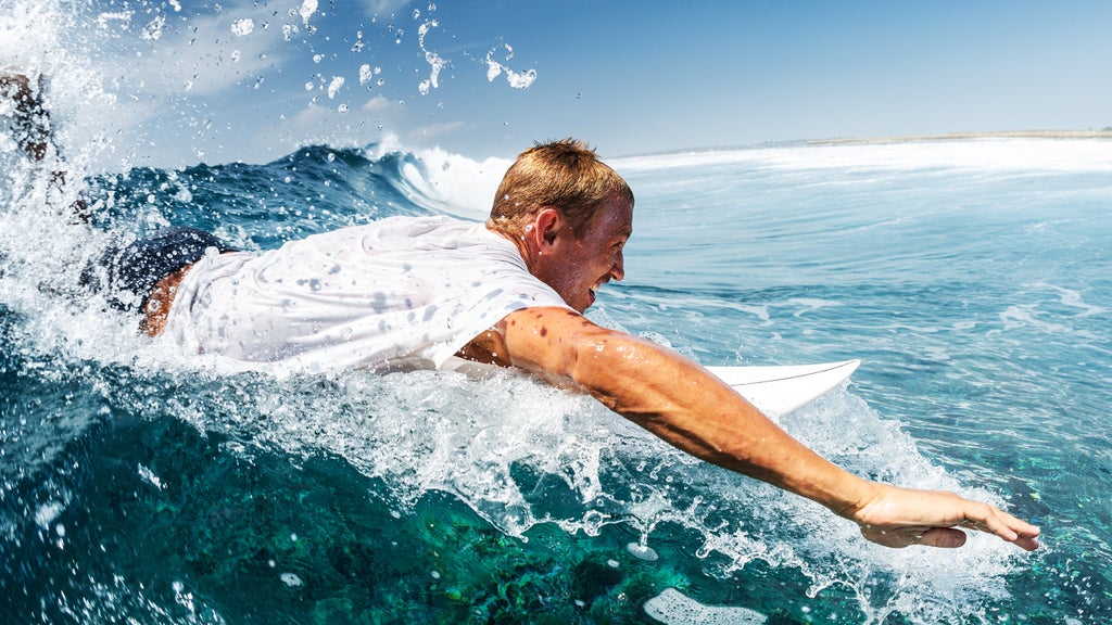 surfer paddling on his board