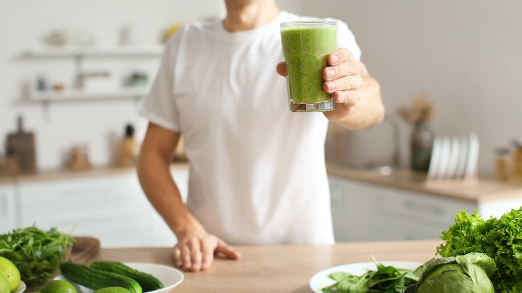 young man enjoying a green smoothie