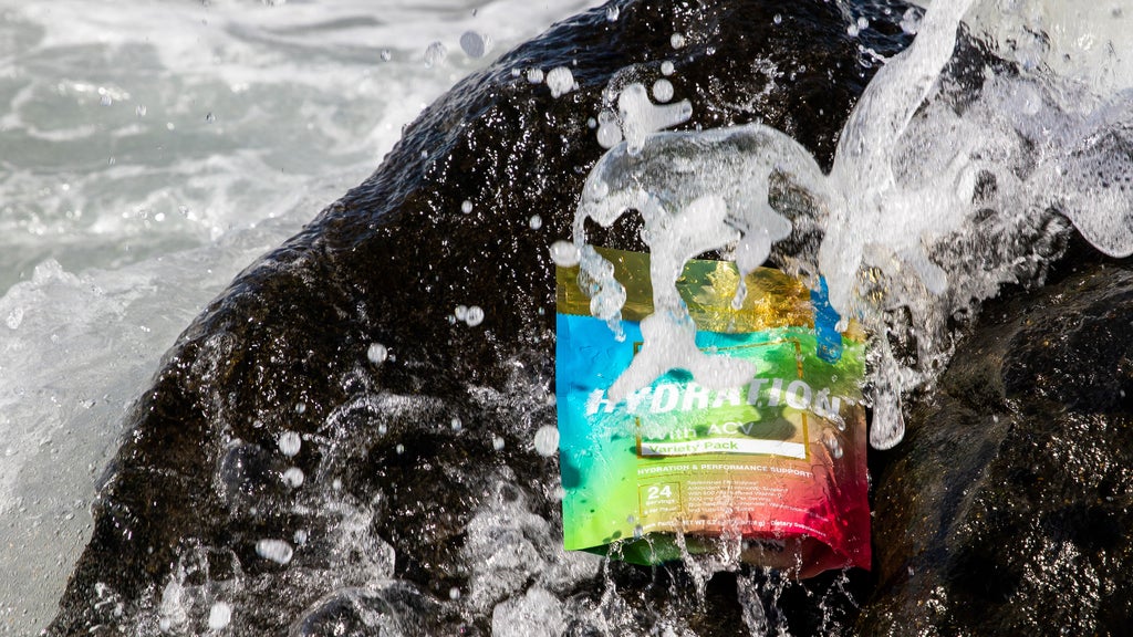 Essential elements Hydration Variety Pack on a rock at the beach