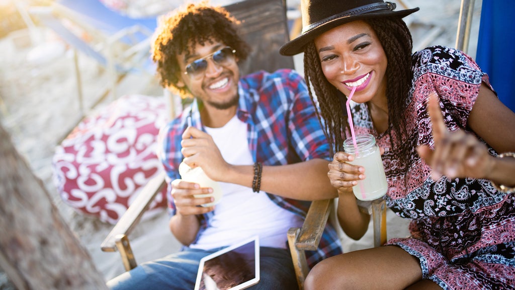 a couple drinking cocktails at the beach