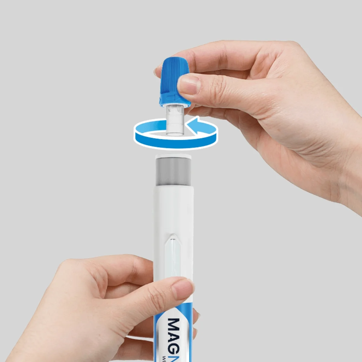 Hands twisting the needle cover off a Magnitude autoinjector before injection