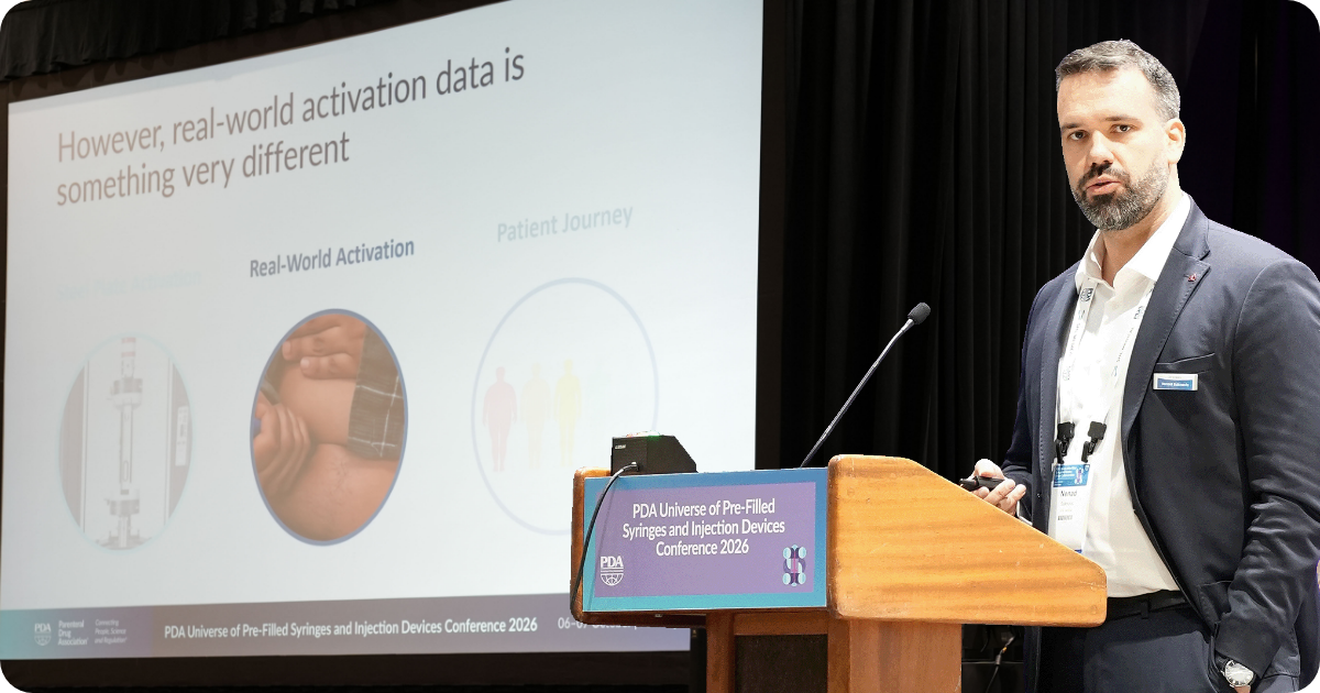 Nenad Suknovic of SHL Medical presenting autoinjector activation force research on stage at PDA Universe 2026.