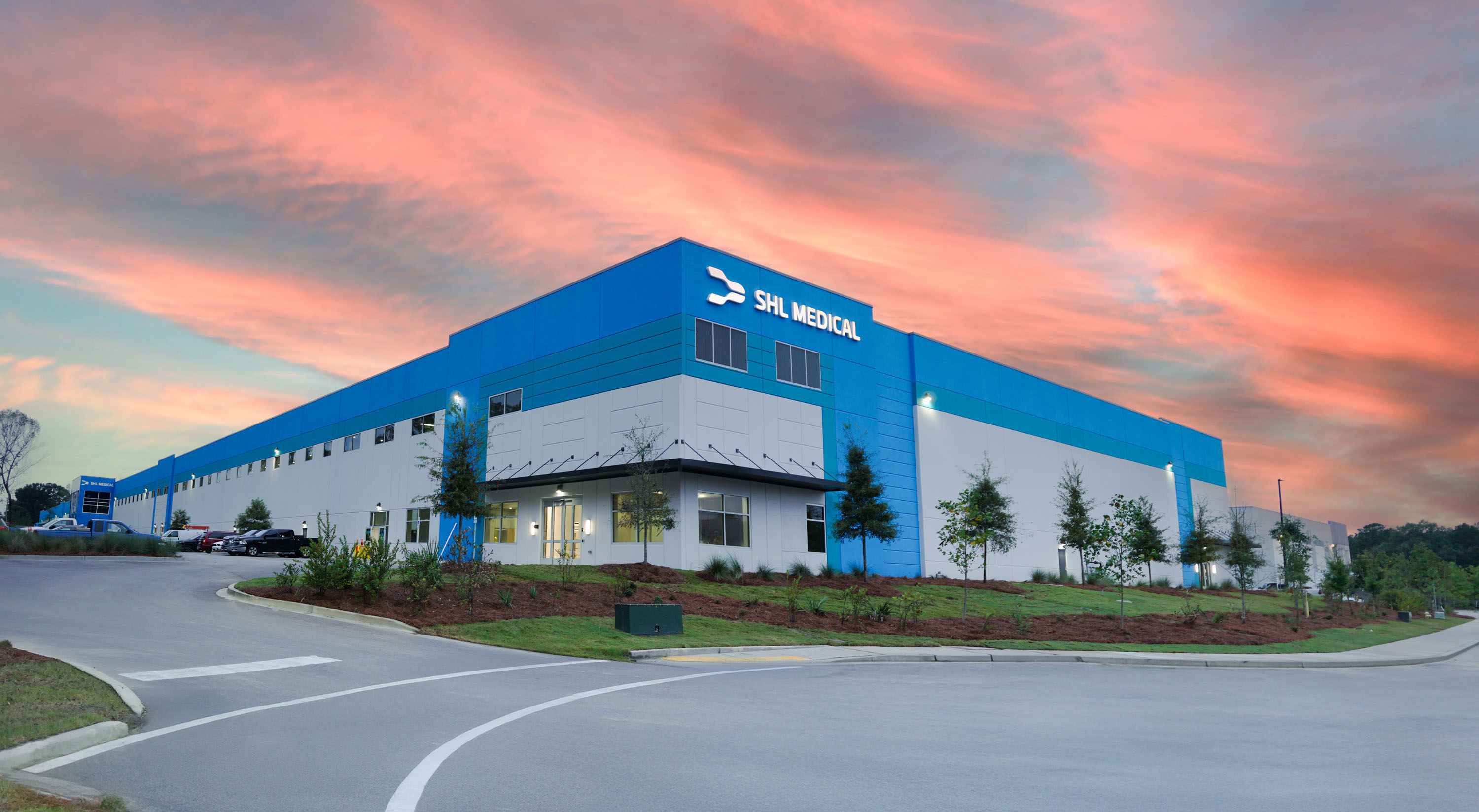 Office building shown against a colorful sunset. SHL Medical’s manufacturing site in North Charleston, USA, was opened in 2025 and is equipped with advanced manufacturing capabilities.