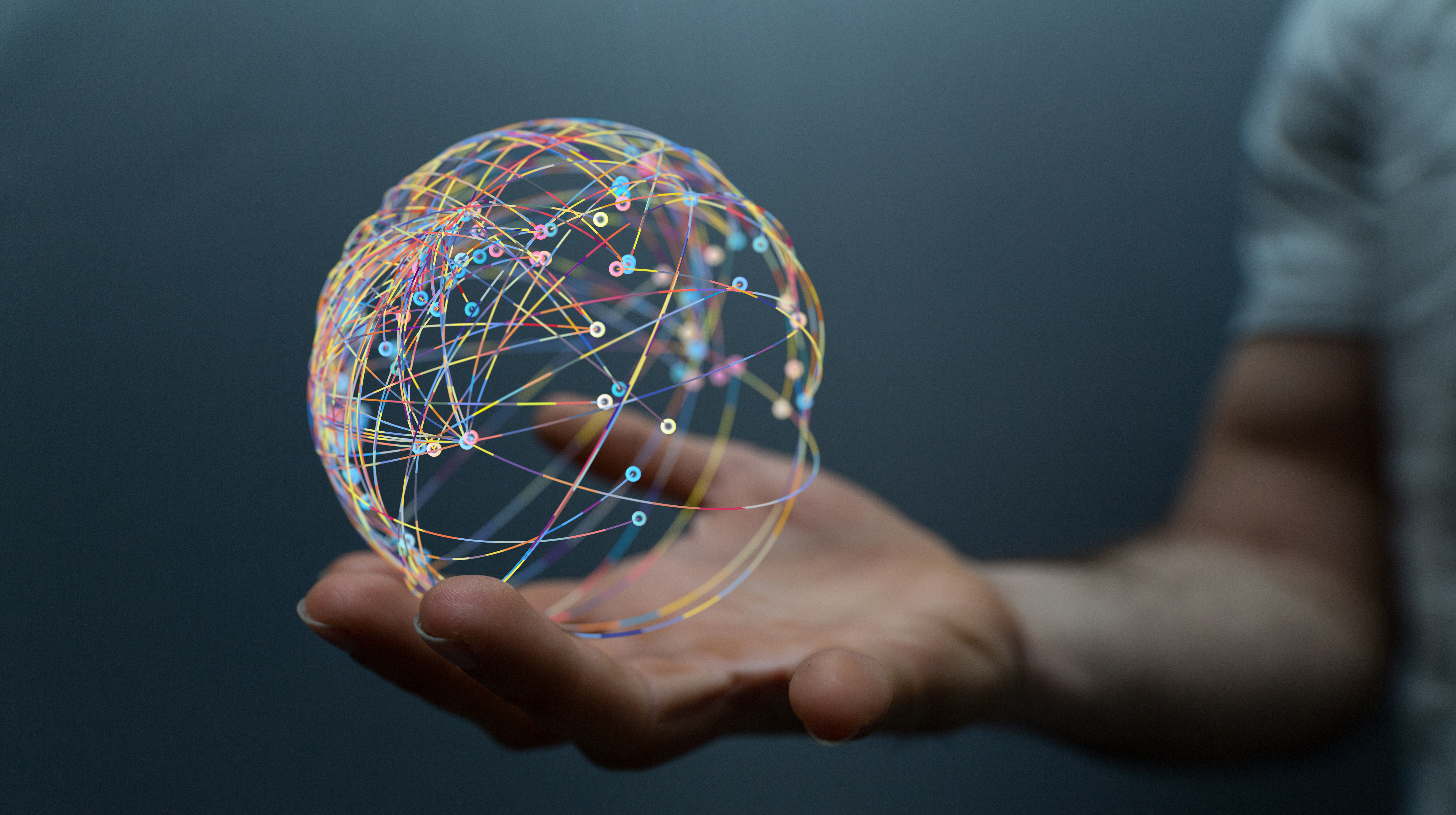 Hand holding a digital network sphere, representing SHL Medical’s AI capabilities and culture of technology-driven innovation.