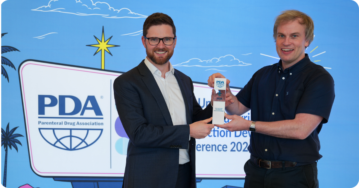 Alex Lyness of SHL Medical and John Burke of Team Consulting holding the Partnership Innovation Award at PDA Universe 2026. 
