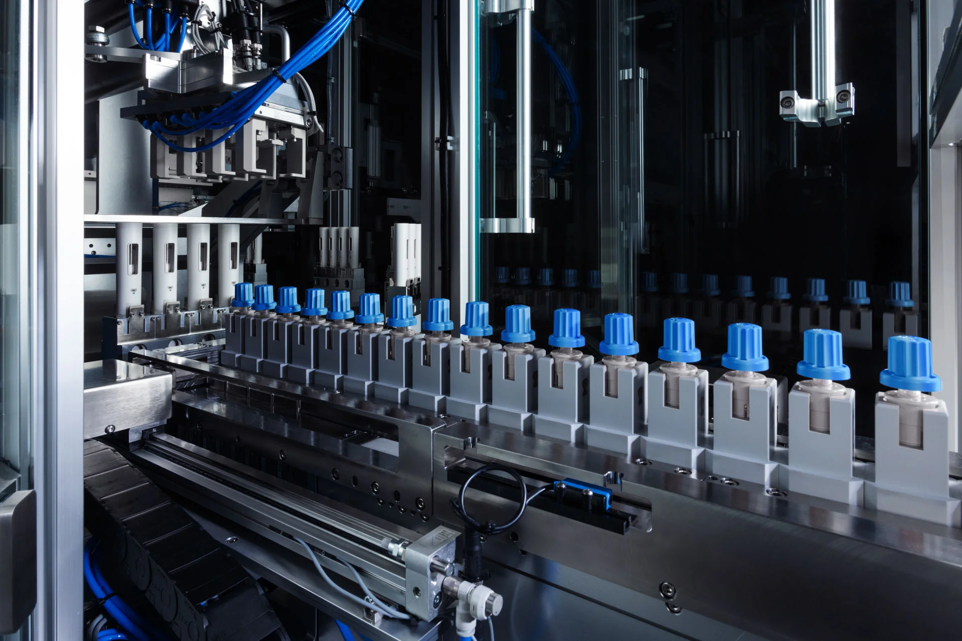 Close-up of SHL Medical’s Reunite dual-chamber cartridge autoinjector front sub-assembly being fed into SHL Advantec’s AOU automated final assembly machine on the manufacturing floor.