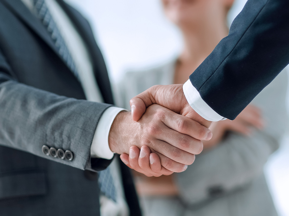 Business handshake representing SHL Medical's industry partnerships