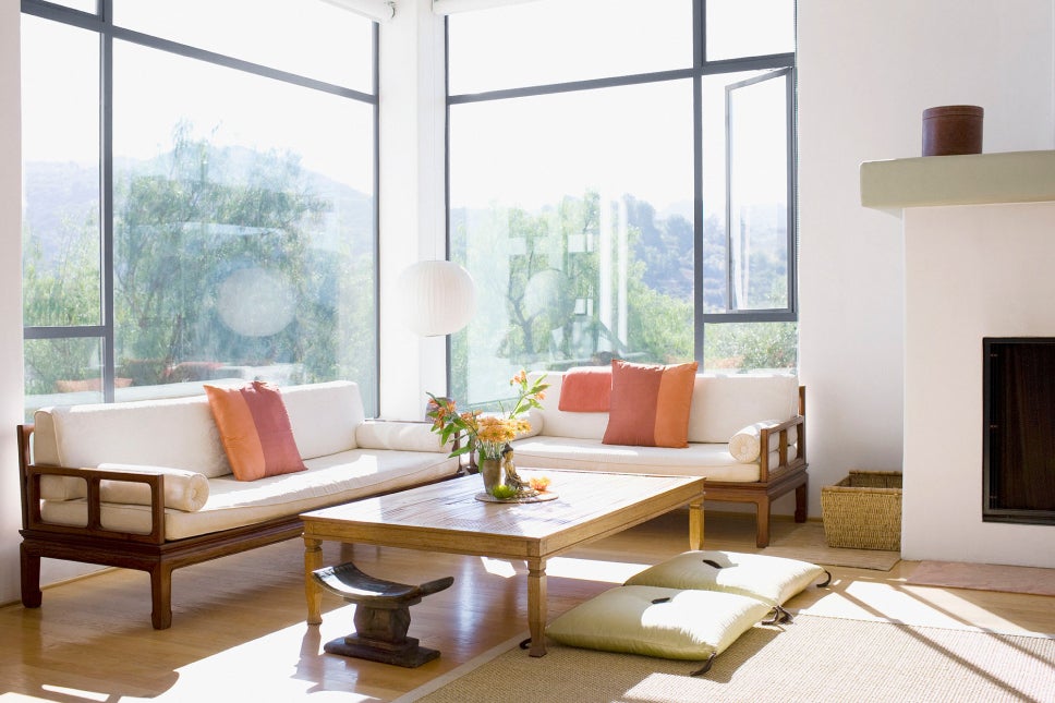 A living room with natural light and tons of large windows
