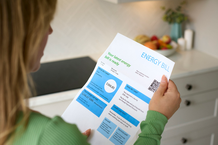 Woman looking at her home energy bill.