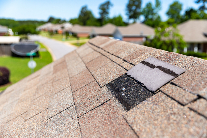 Brown roof with one shingle removed Brown roof with one shingle removed