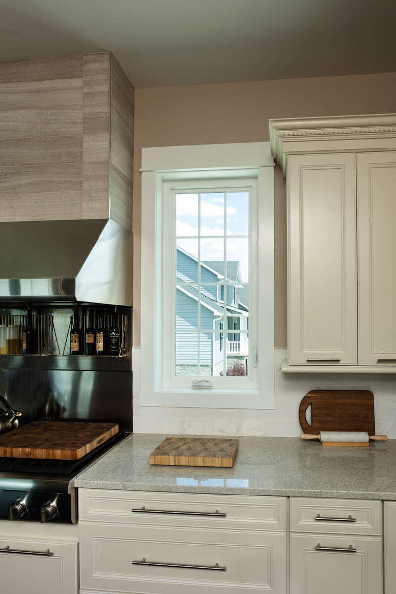 casement window above kitchen counter provides natural light and a clear view, with clean lines and smooth operation that complements modern cabinetry