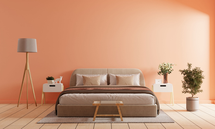 A bedroom painted in Peach Fuzz, the Pantone 2024 Color of the Year