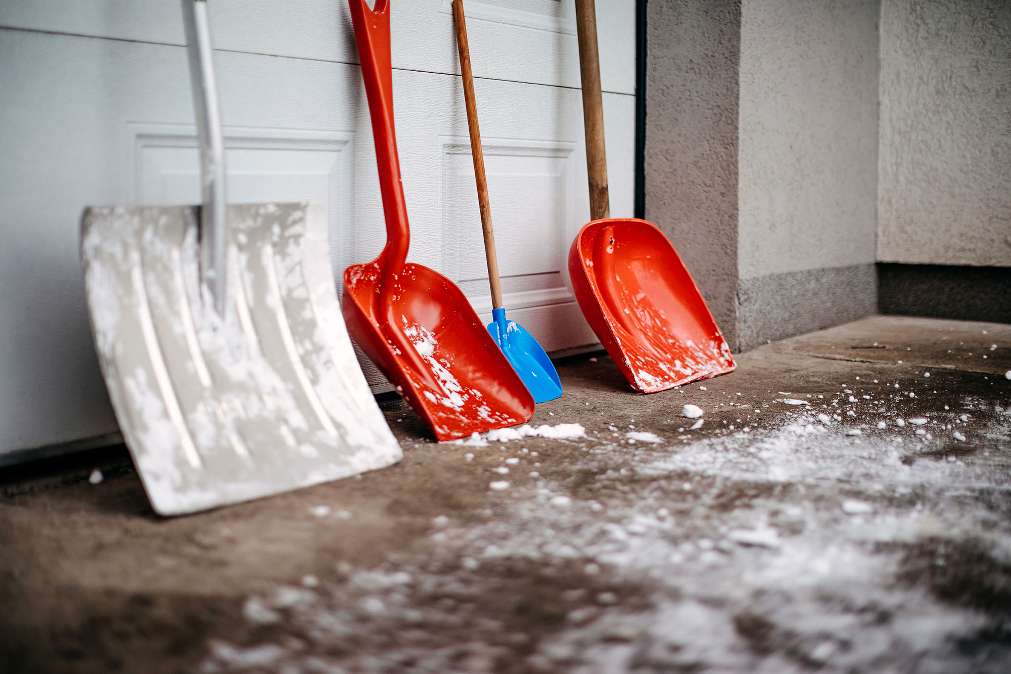 A row of snow shovels ready for use winterizing a home.