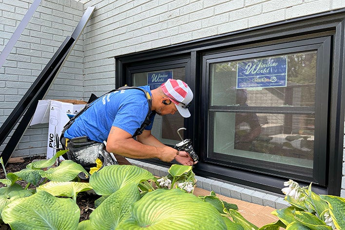 Man installs window Man installs window