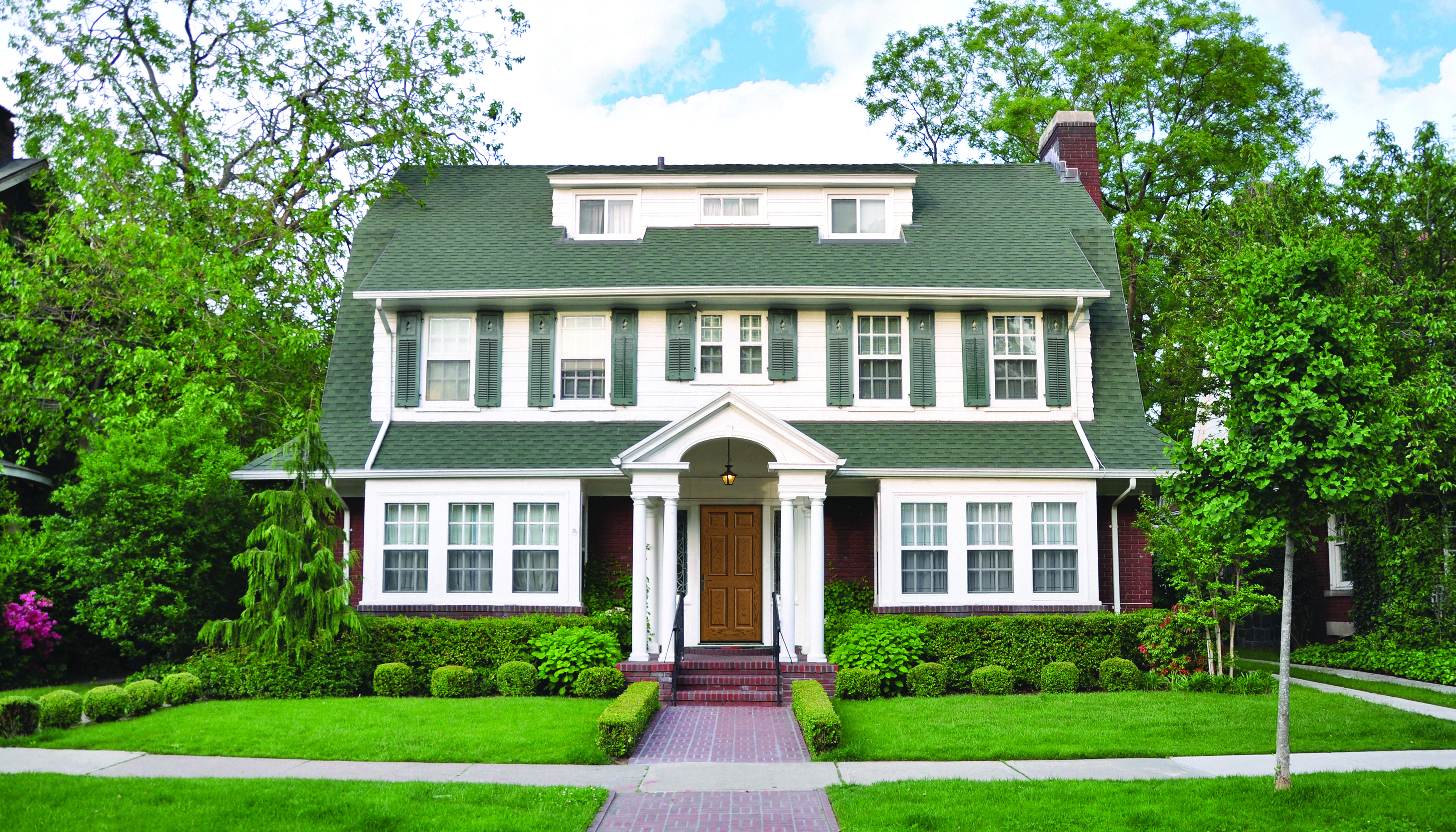 House with white siding and gray shutters, a popular house and shutter color combination.