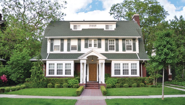 House with white siding and gray shutters, a popular house and shutter color combination.