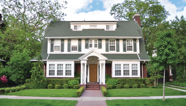 House with white siding and gray shutters, a popular house and shutter color combination.