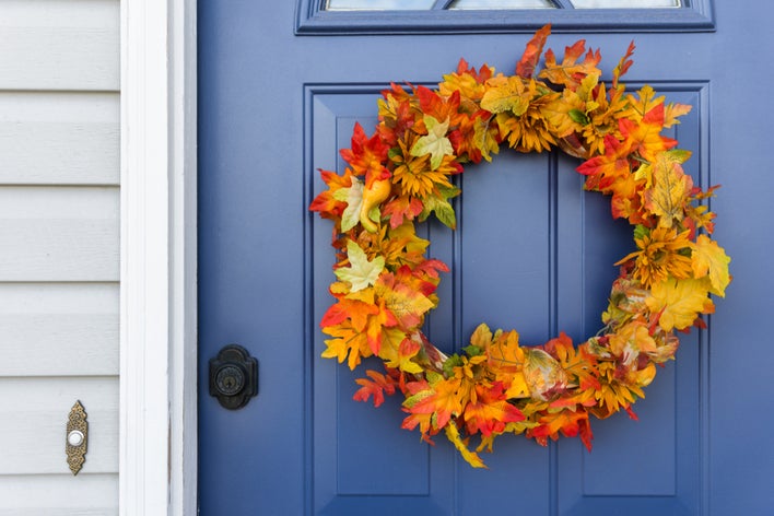 A fall wreath on a blue front door
